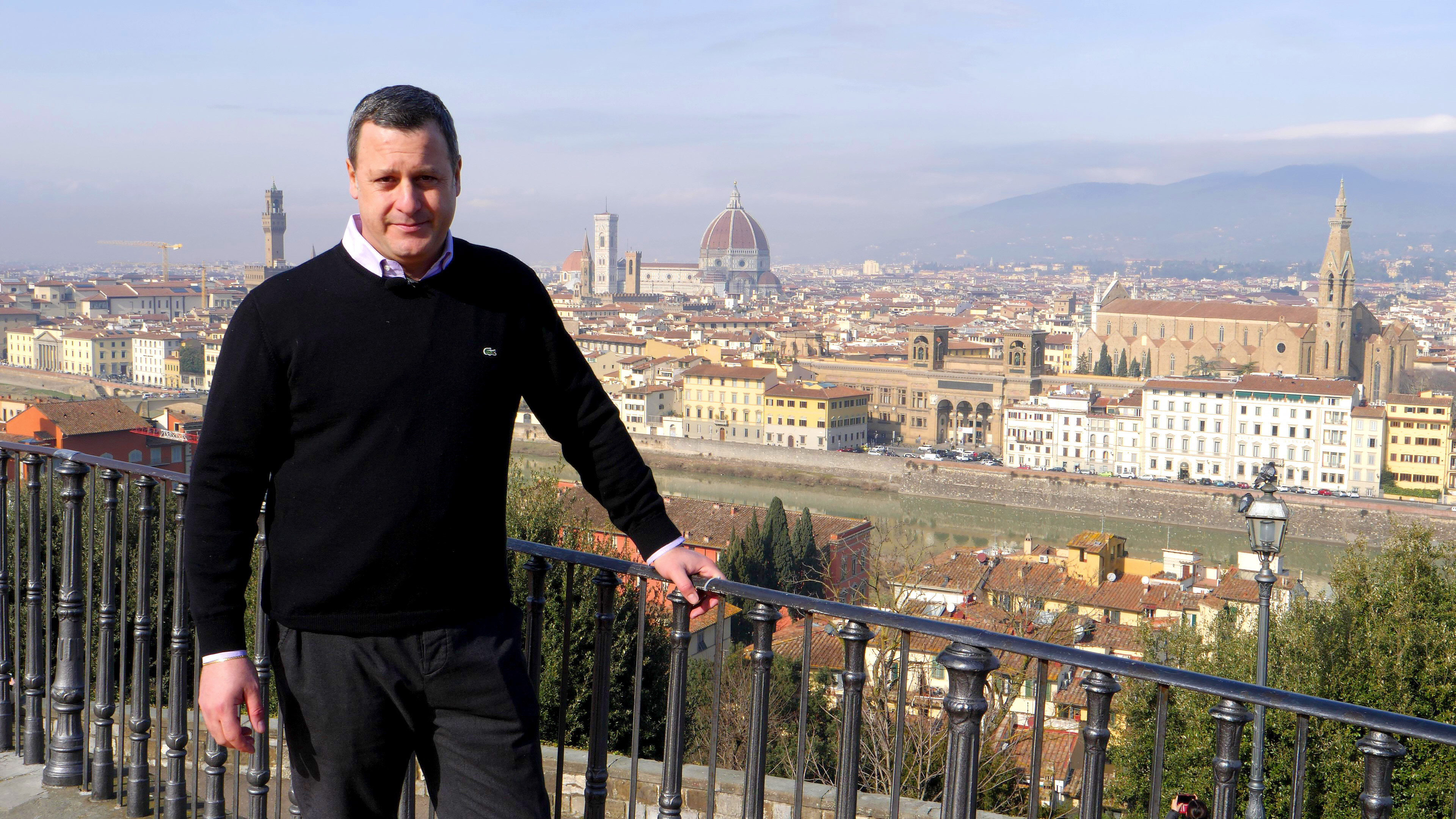 Dr. Rocky Ruggiero stands at the Piazzale Michelangelo to give an overview of the historic buildings that make up the iconic skyline of Florence, Italy.